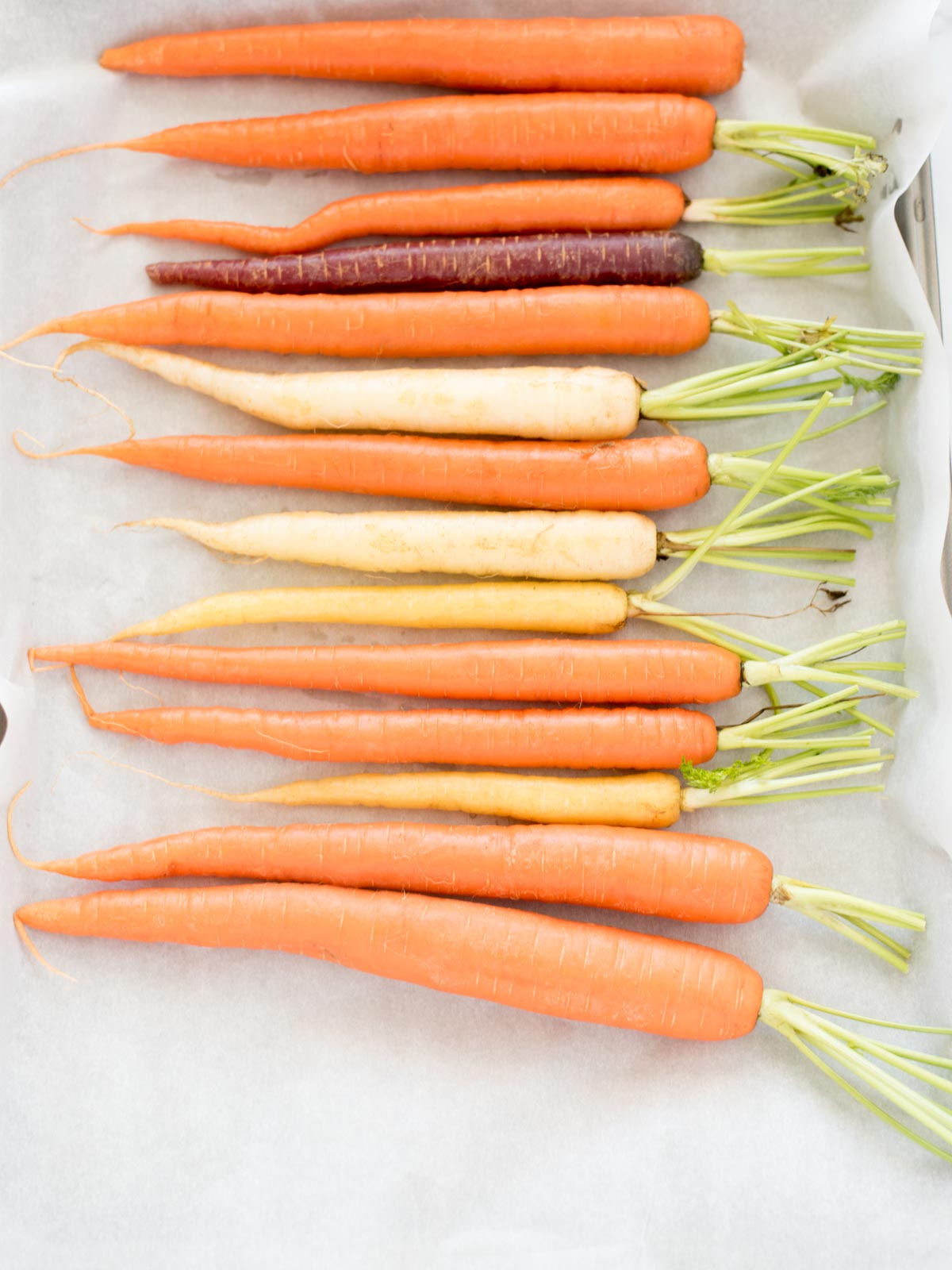 carrots on parchment lined baking sheet