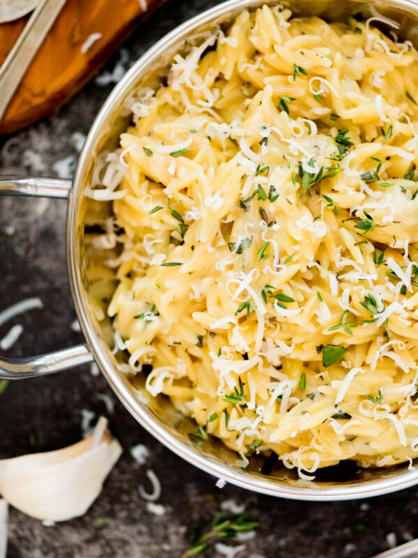 parmesan orzo topped with fresh herbs and grated parmesan