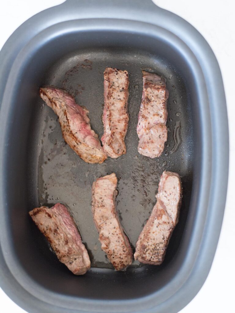 boneless beef ribs searing in pot