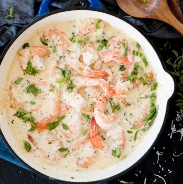 creamy garlic shrimp with parmesan in a blue enamel cast iron skillet