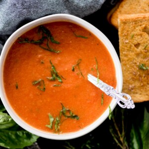 creamy roasted tomato basil soup topped with basil paired with a grilled cheese