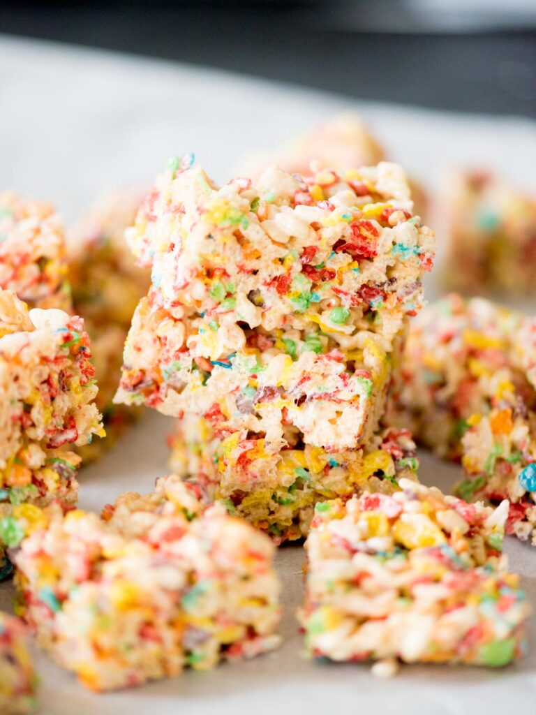 fruity pebbles rice krispie treats stacked on top of each other