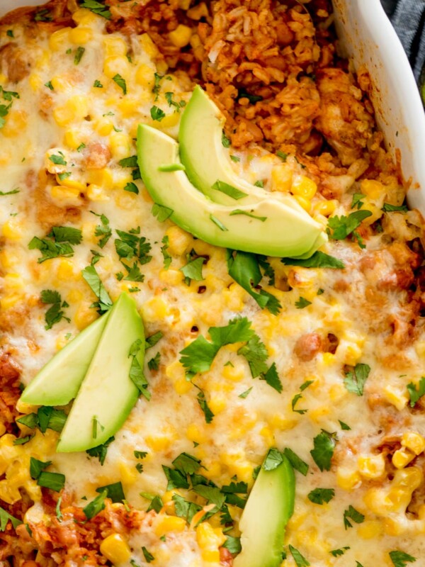 mexican rice casserole topped with cilantro and avocado