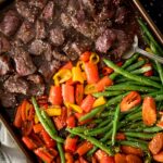 easy sheet pan beef teriyaki cooked on a baking sheet with a serving spoon