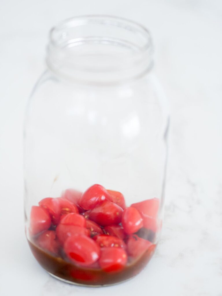 balsamic vinaigrette and tomatoes in a mason jar
