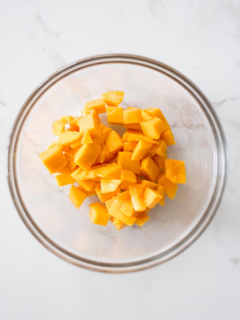 chopped mango in a mixing bowl