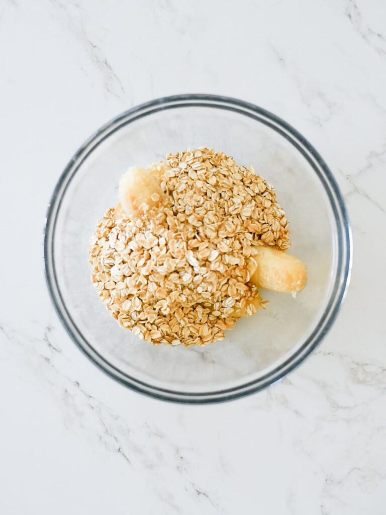 banana and oats in a mixing bowl