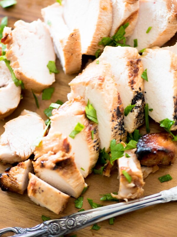 sliced marinated grilled chicken on a cutting board