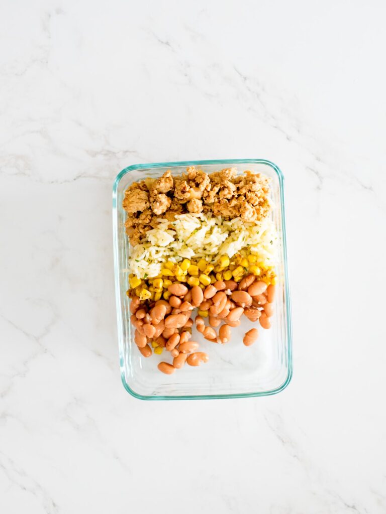 turkey, rice, corn, and beans in a glass container