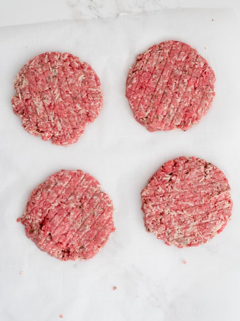 raw cheesy ranch burger patties on parchment paper