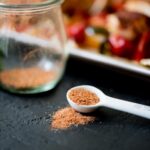 homemade fajita seasoning in a jar and measuring spoon