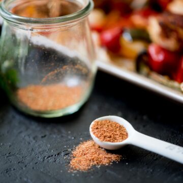 homemade fajita seasoning in a jar and measuring spoon