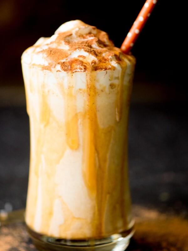 pumpkin milkshake in a glass with a caramel drizzle