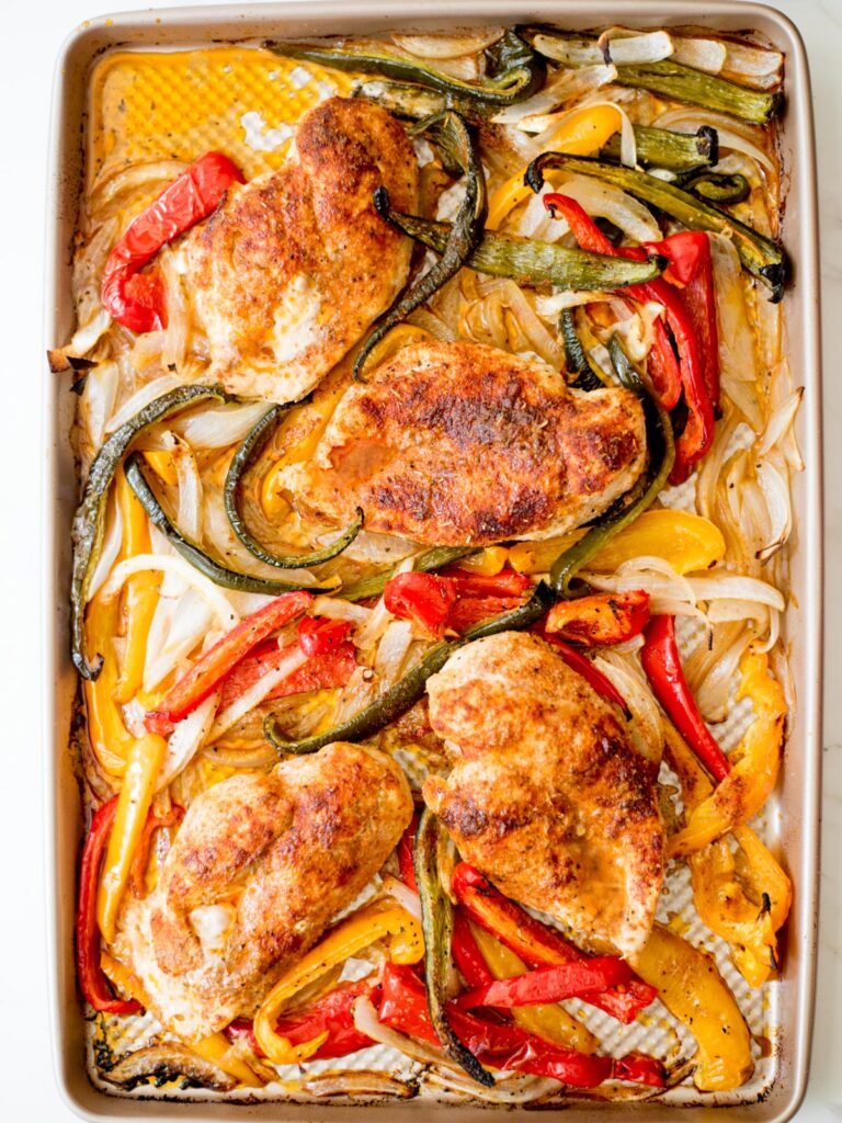 cooked vegetables and chicken on a sheet pan