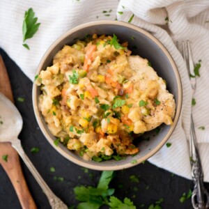 chicken and stuffing in a bowl topped with parsley