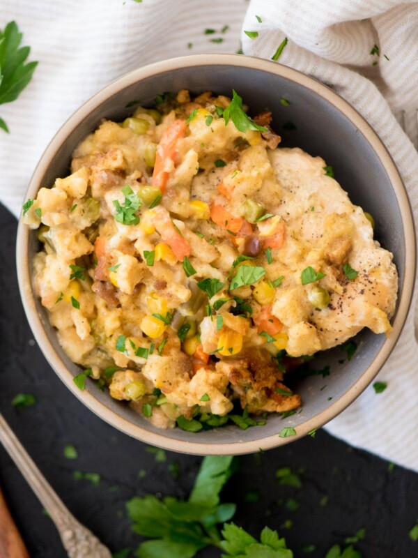 chicken and stuffing in a bowl topped with parsley