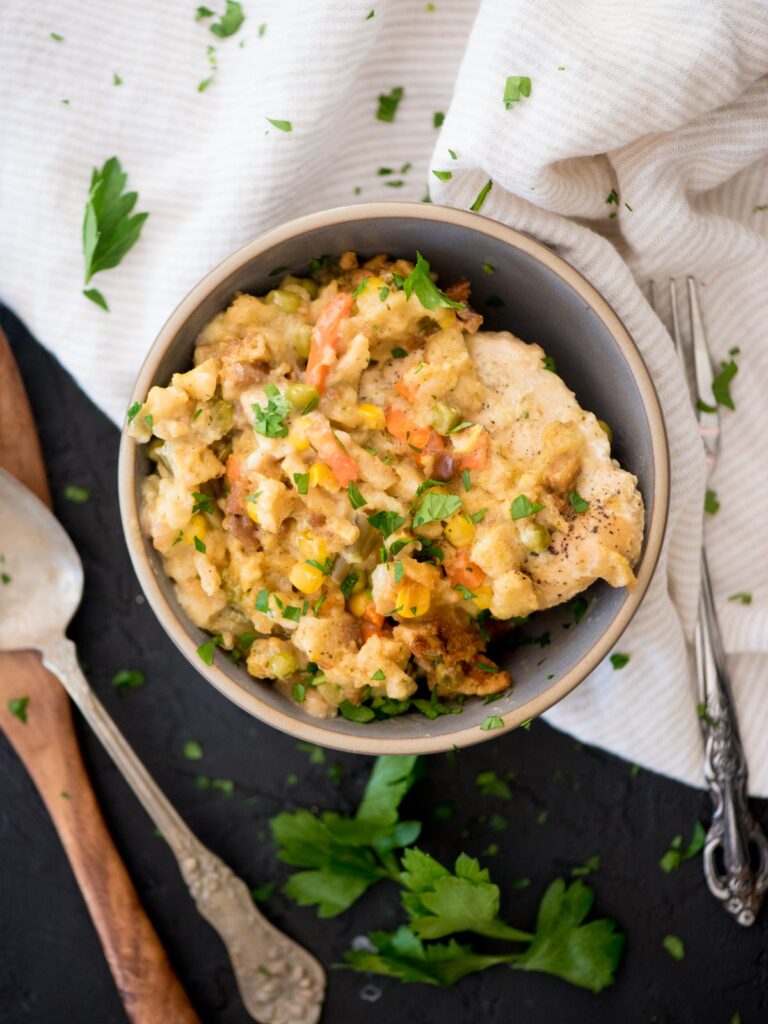 chicken and stuffing in a bowl topped with parsley