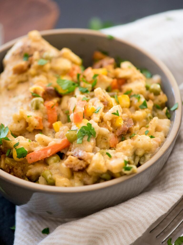 chicken and stuffing in a bowl topped with parsley