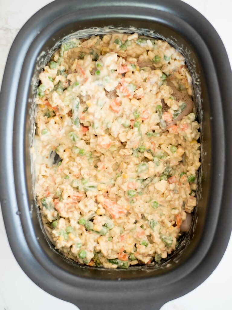 uncooked chicken and stuffing casserole in the crockpot