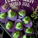 A platter of purple-dyed Halloween deviled eggs with green filling.