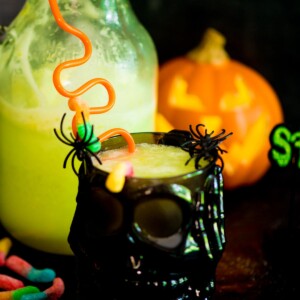 bug juice drink in a skull cup with plastic spiders and gummy worms