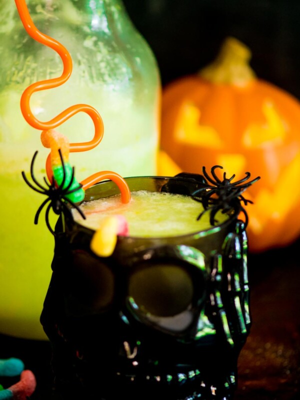 bug juice drink in a skull cup with plastic spiders and gummy worms
