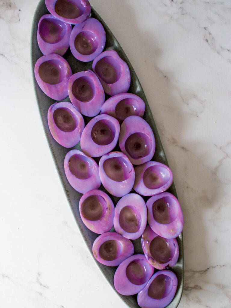 purple hard boiled eggs on a platter