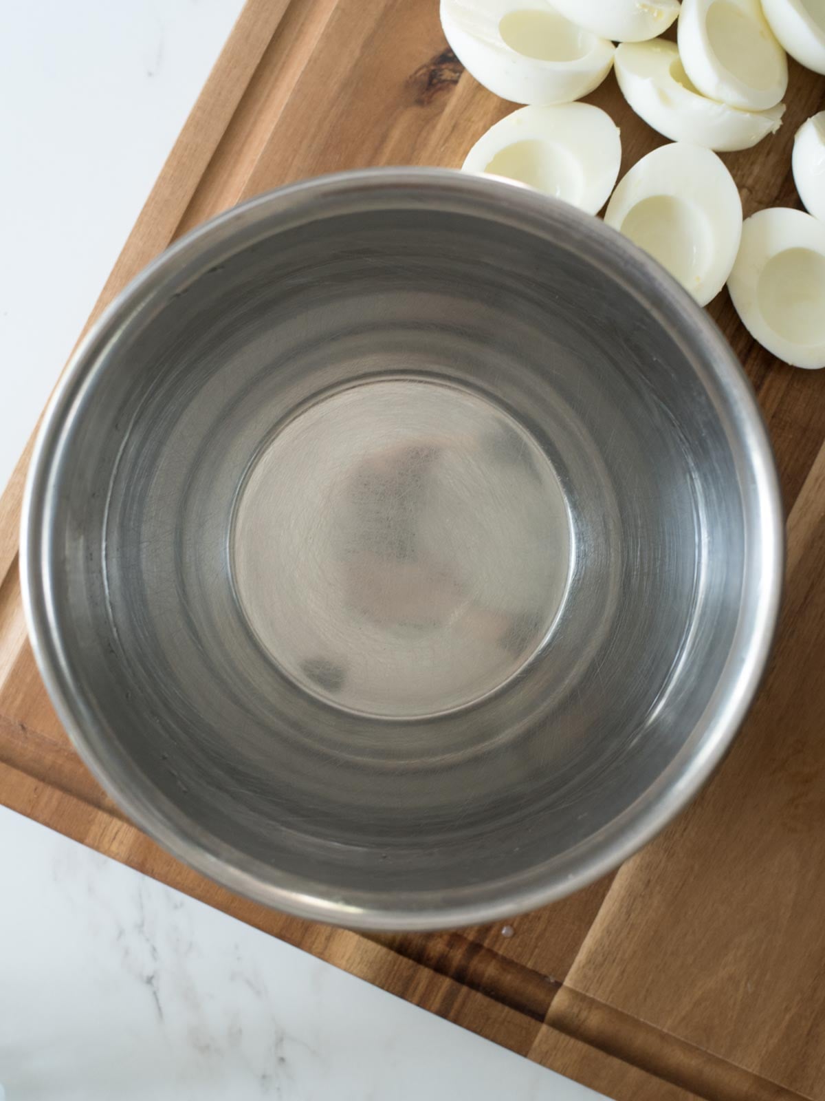 mixing bowl of water on a cutting board
