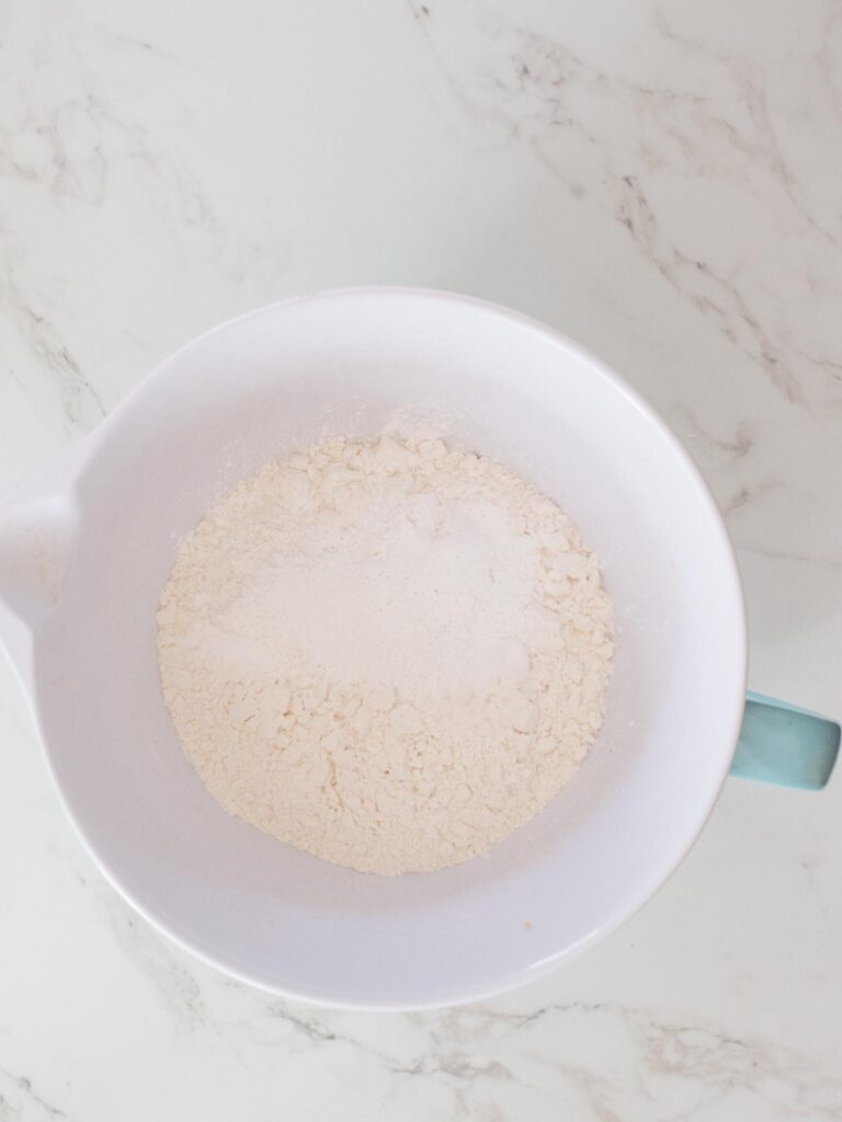 flour with baking powder, baking soda, and salt in a mixing bowl