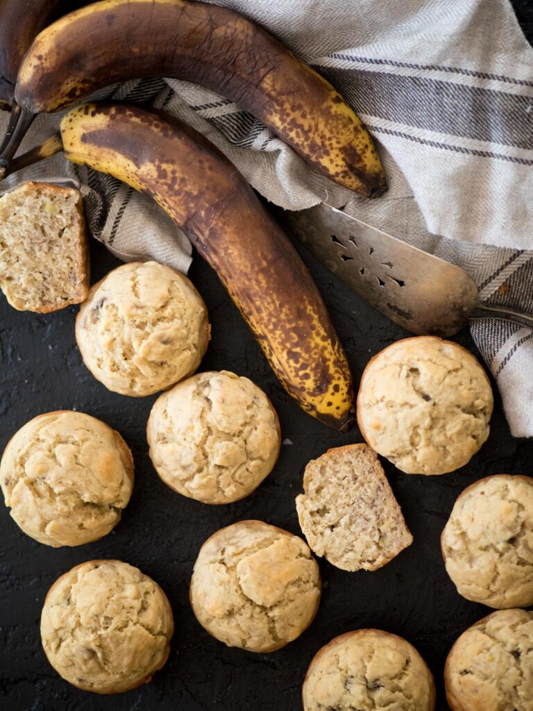 banana muffins with a tea towel and browned bananas