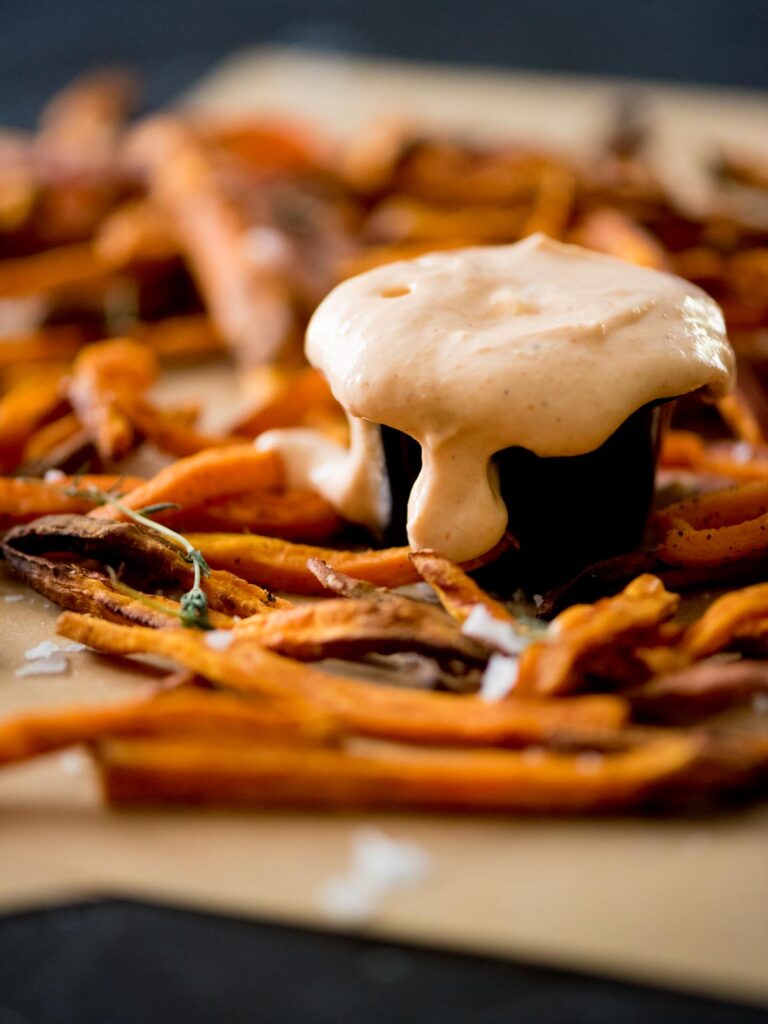 sweet potato fries sauce surrounded by sweet potato fries