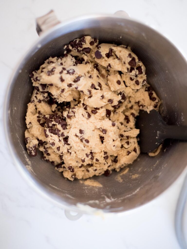 dough for the best chewy chocolate chip cookies in a metal mixing bowl