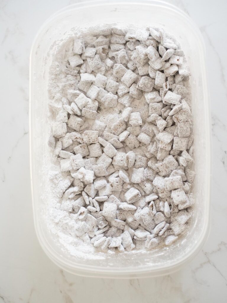 reindeer chow coated in powdered sugar in a container