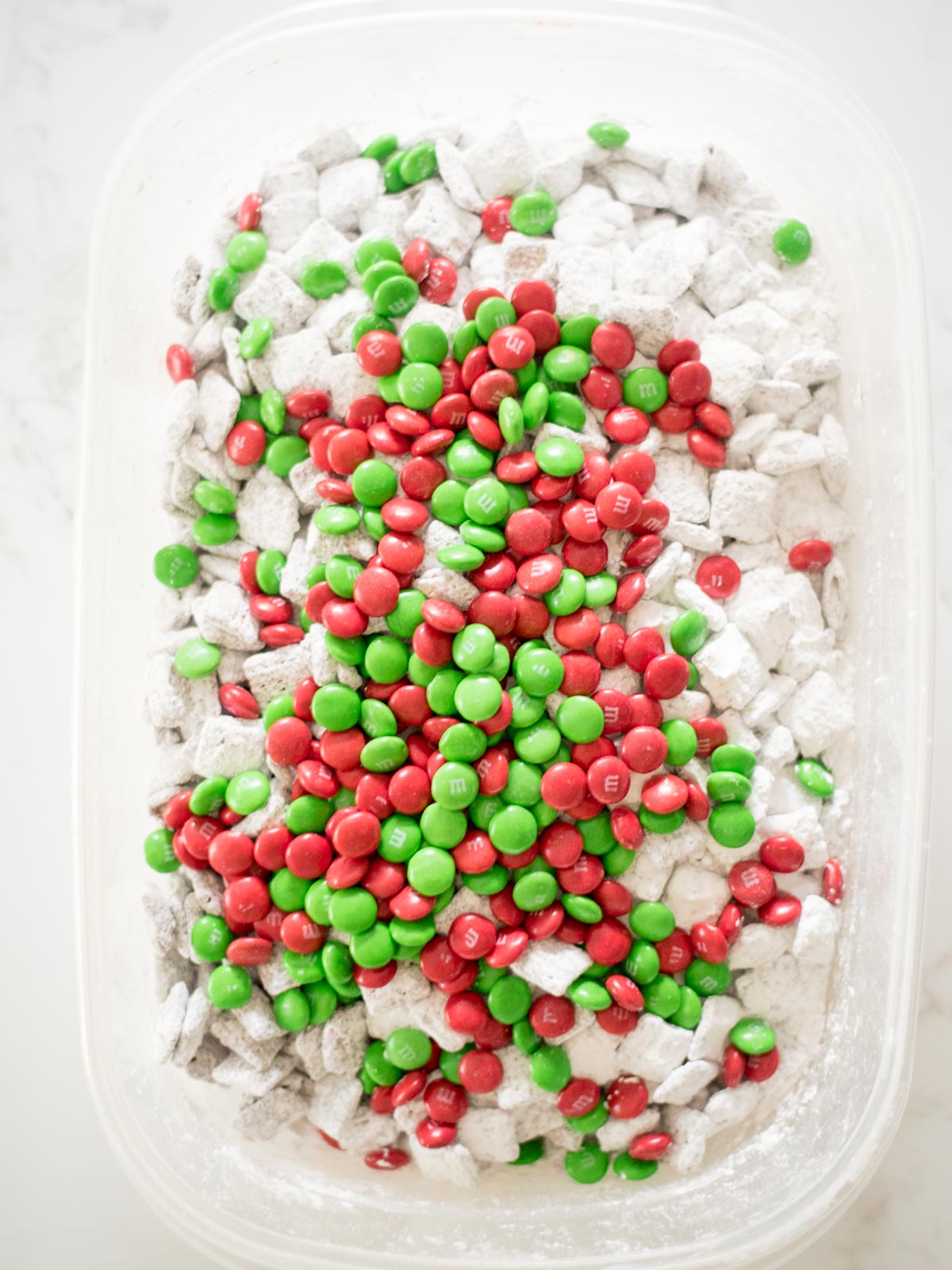 green and red m&m's added to muddy buddies