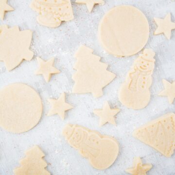 sugar cookies cut into snowmen, trees, stars, and circles