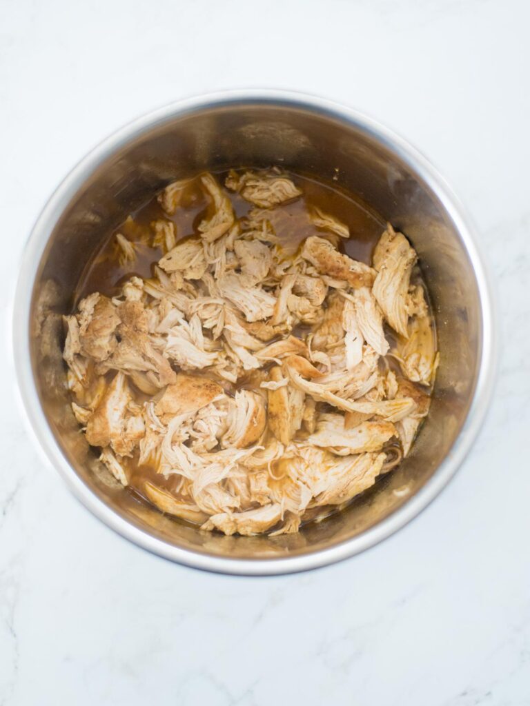 shredded chicken in broth in an instant pot