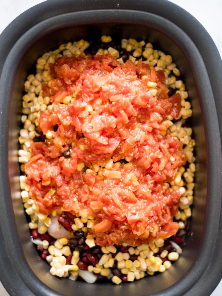 rotel added to chicken, beans, and corn in a crockpot