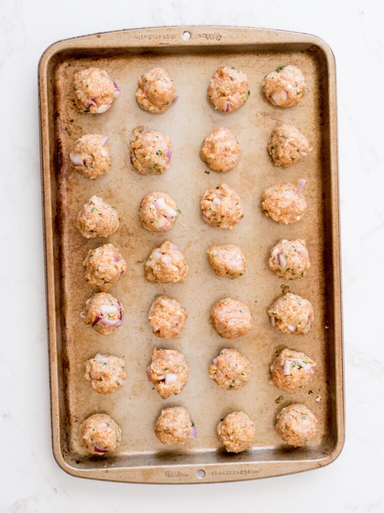 turkey meatballs on a baking sheet before they are baked