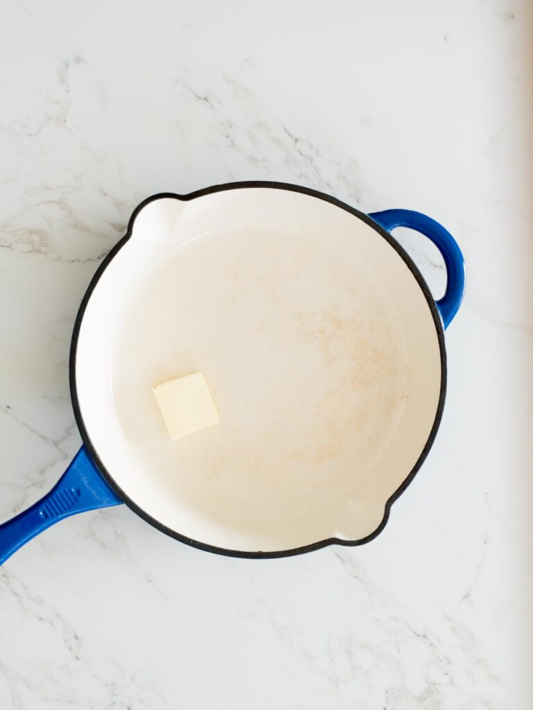 butter added to an enamel cast iron skillet