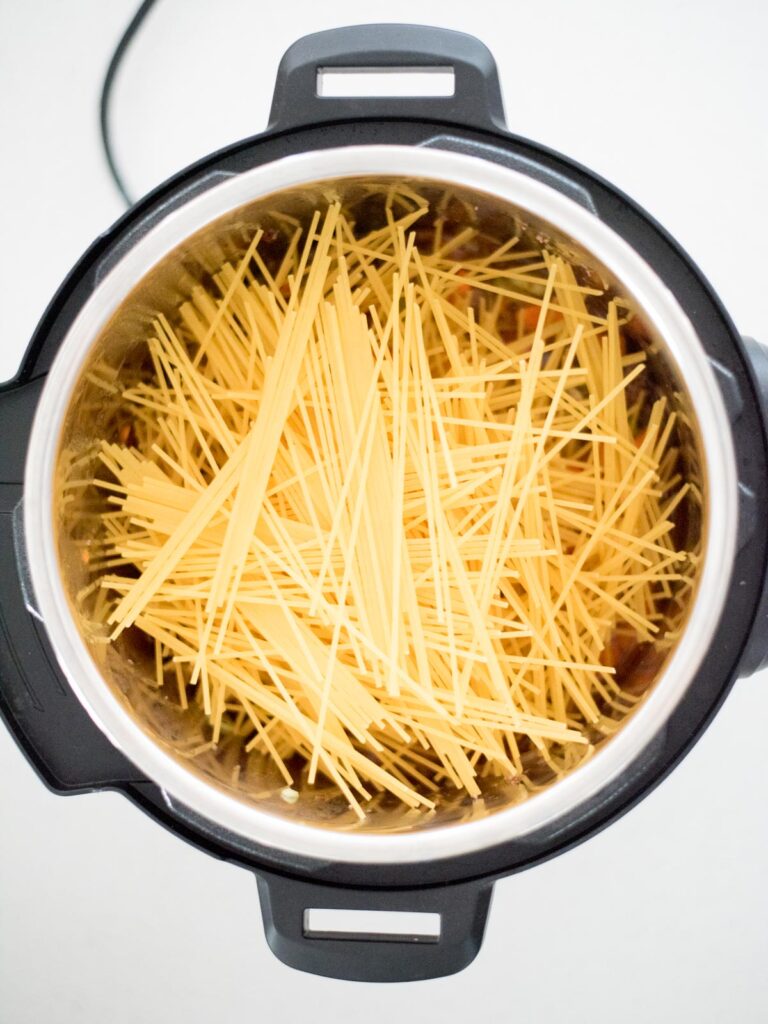spaghetti pasta added to instant pot before cooking