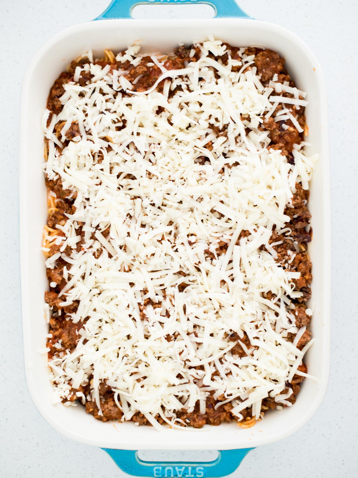 baked spaghetti in a casserole dish before going in oven