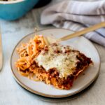 easy baked spaghetti recipe fully cooked and served on a plate with a fork