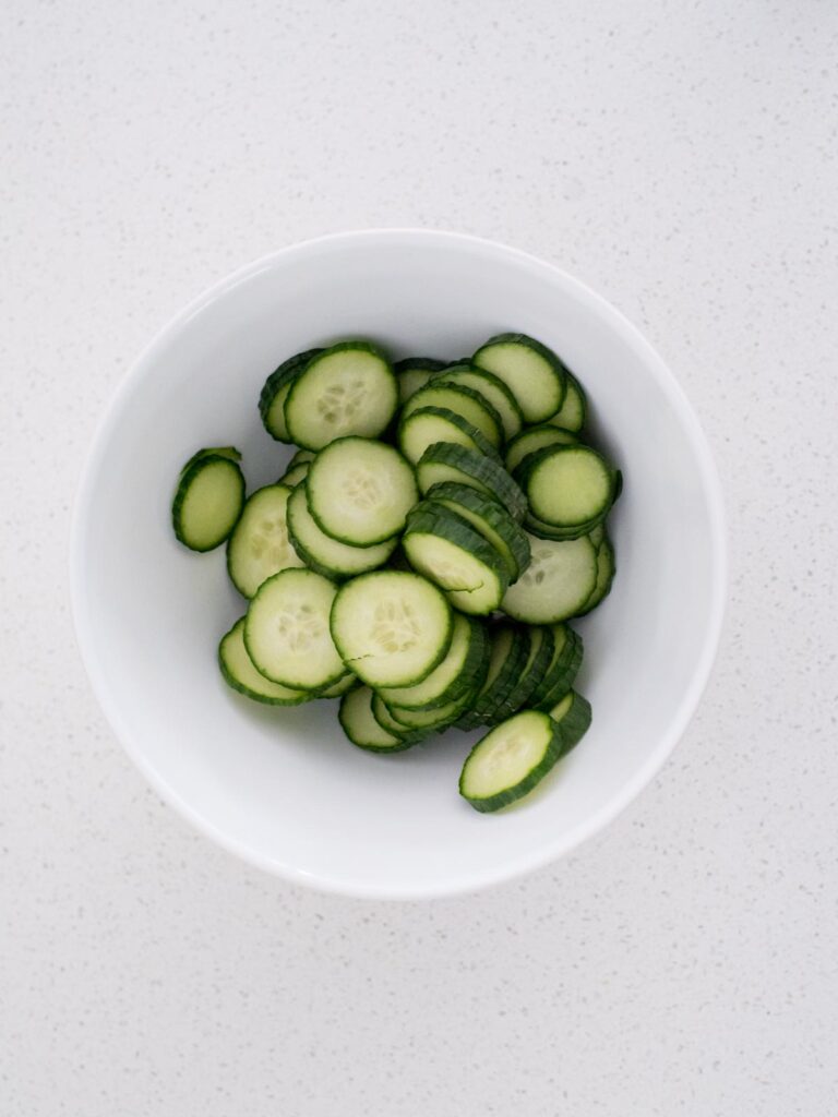 sliced cucumbers in a mixing bowl