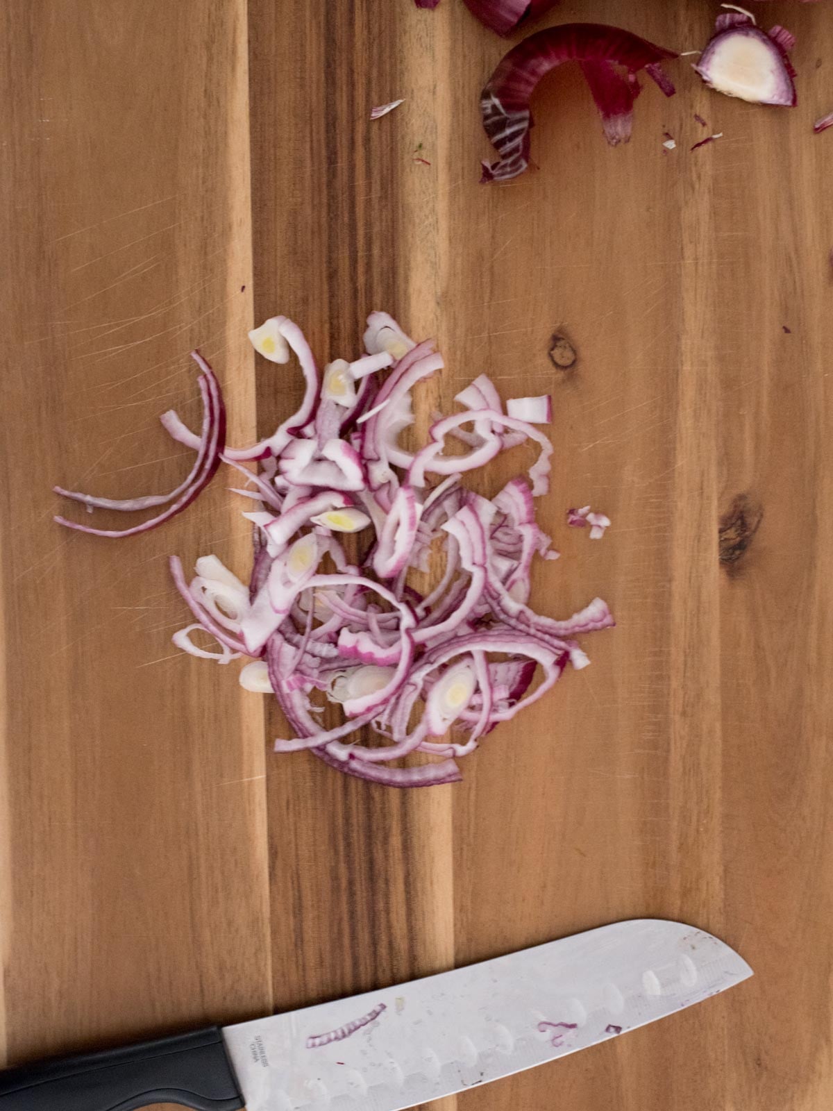 sliced red onions on a cutting board