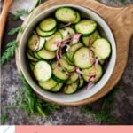 cucumber salad in a bowl with utensils pinterest graphic