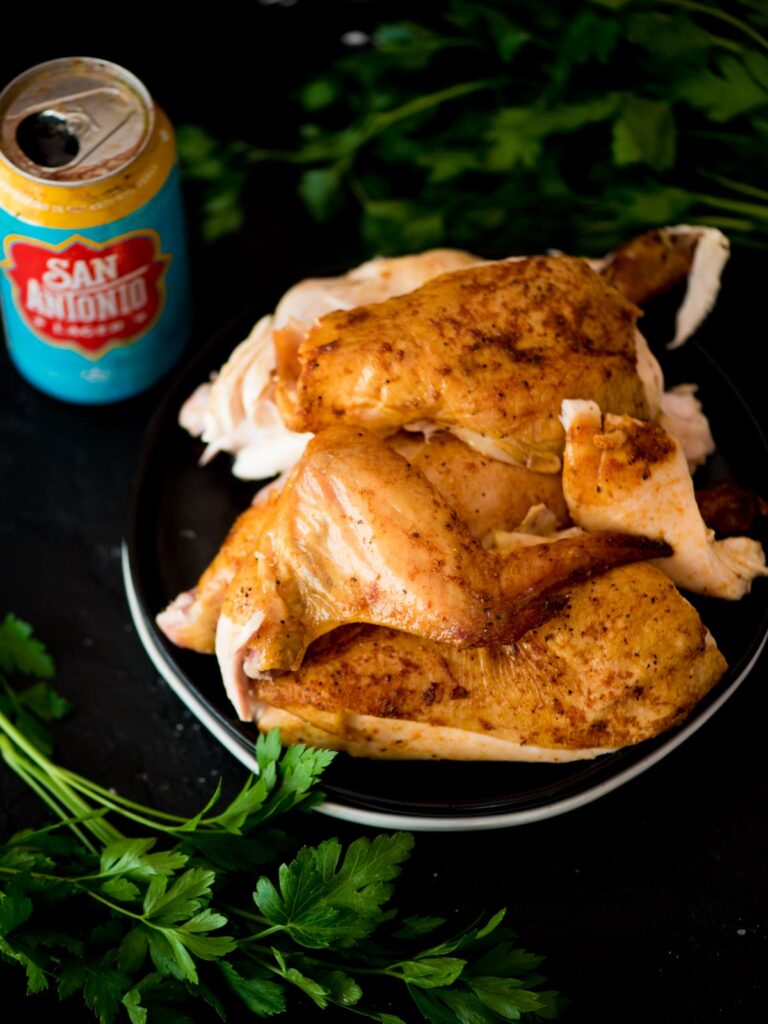 pit boss beer can chicken on a plate surrounded by parsley