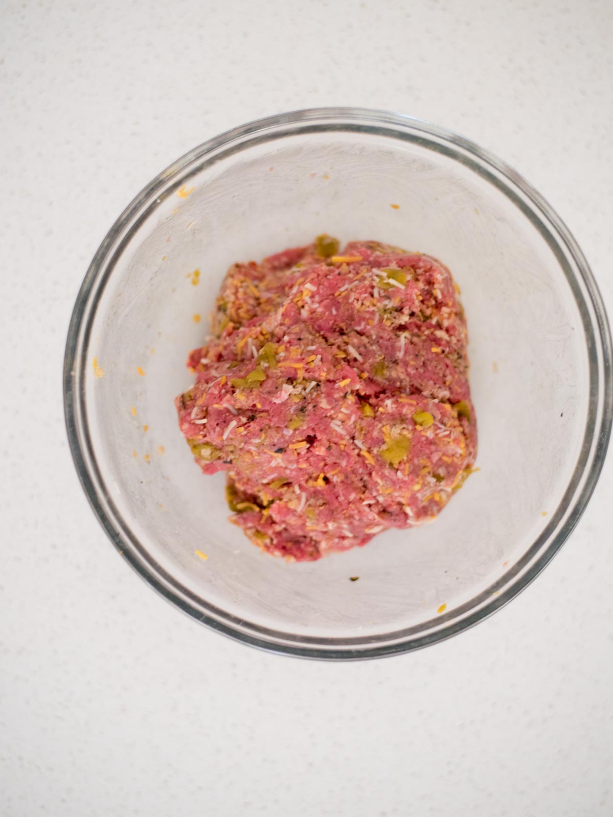 ingredients for smoked burgers mixed together in a bowl