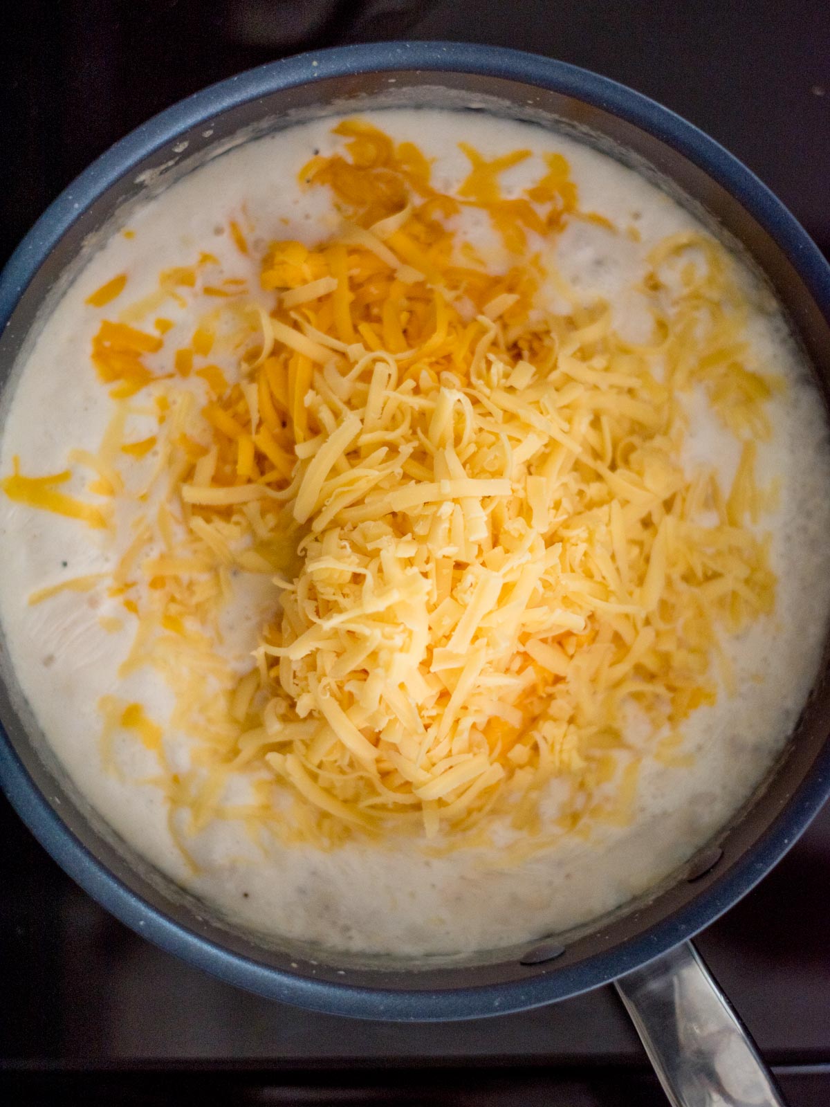 cheeses added to the skillet with the roux and half and half