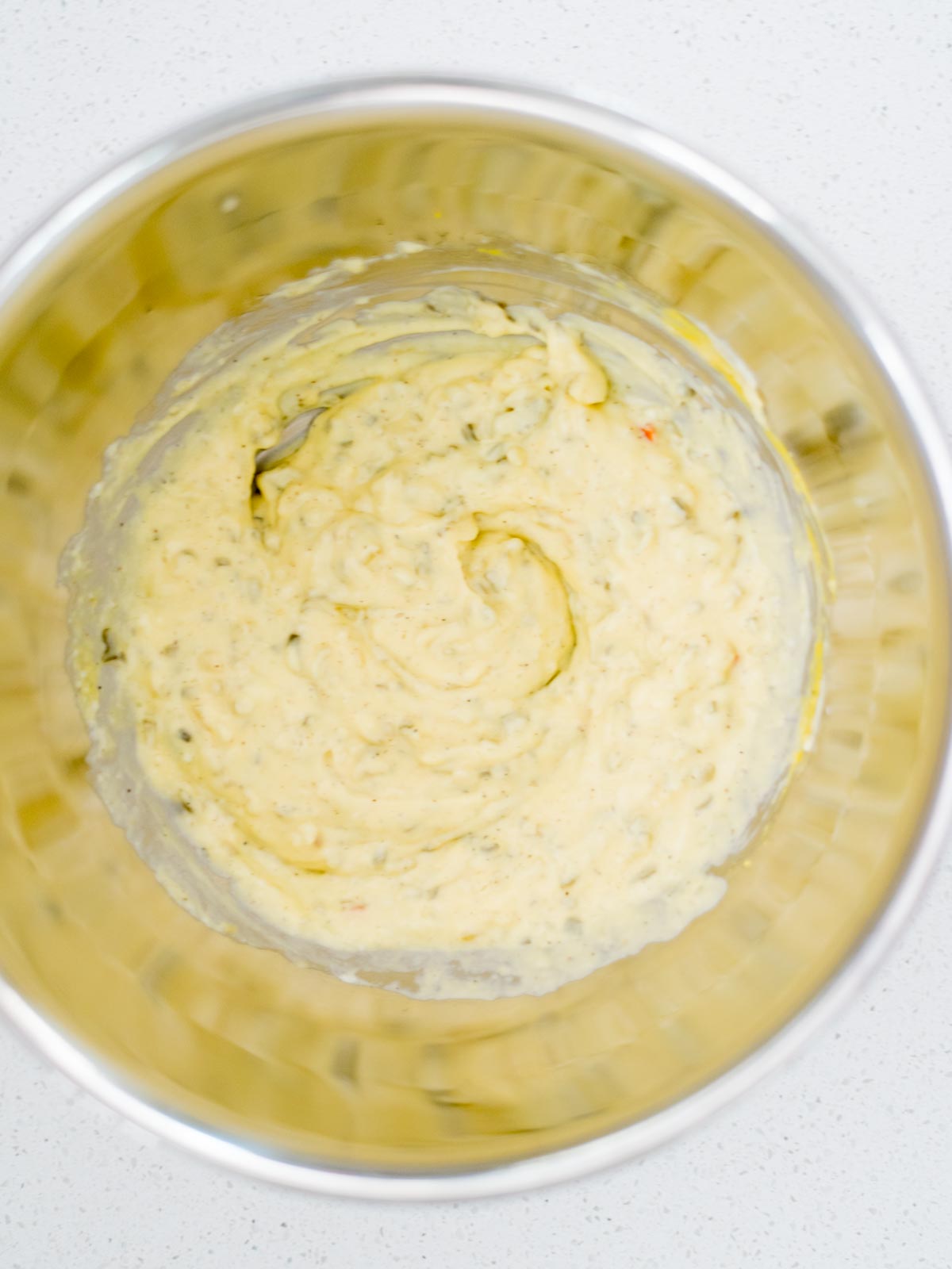 potato salad dressing ingredients mixed together in a mixing bowl