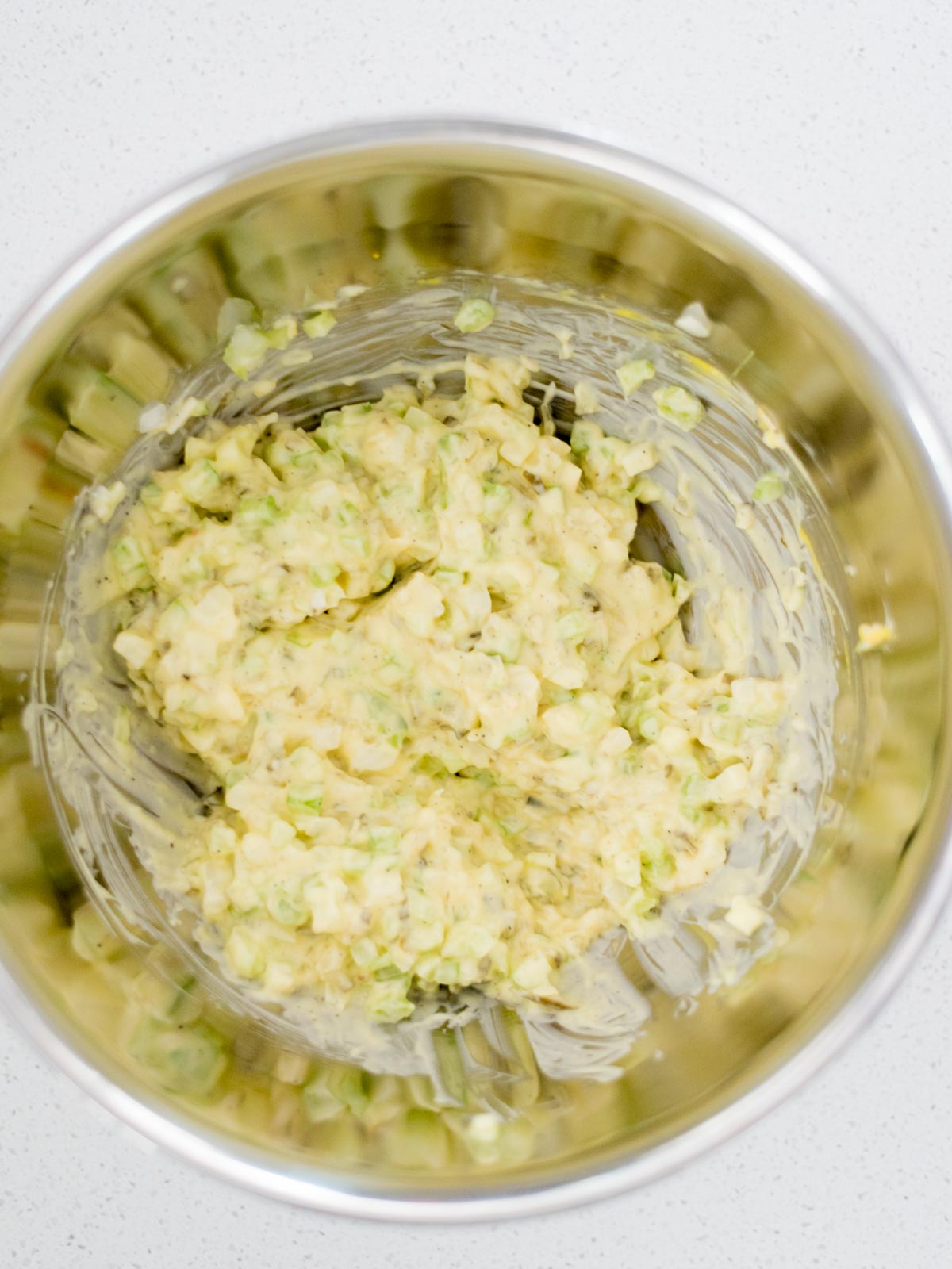 celery and onion mixed together with potato salad dressing